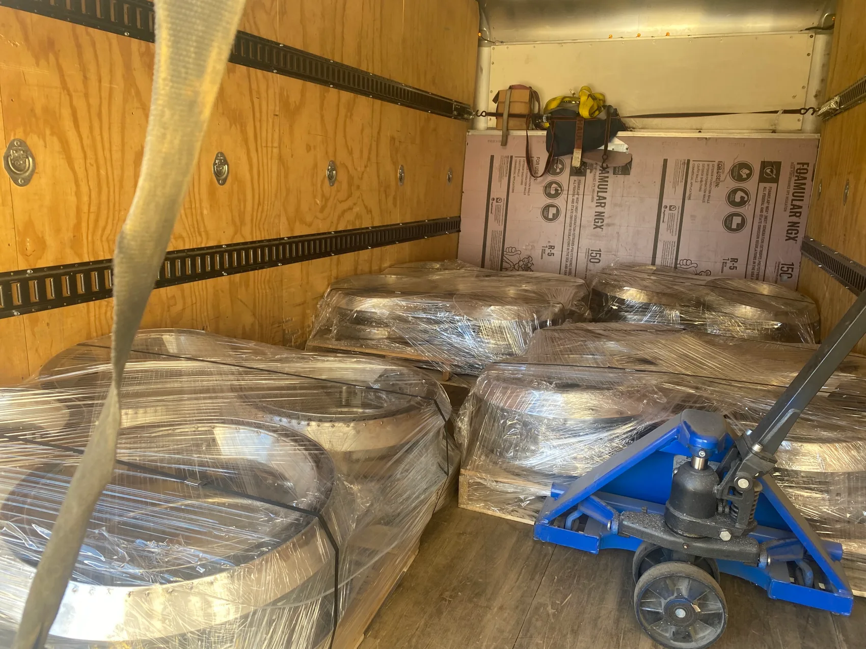 Finished burners shrink-wrapped, palletized, and loaded for delivery - we package them and get them to the dock.