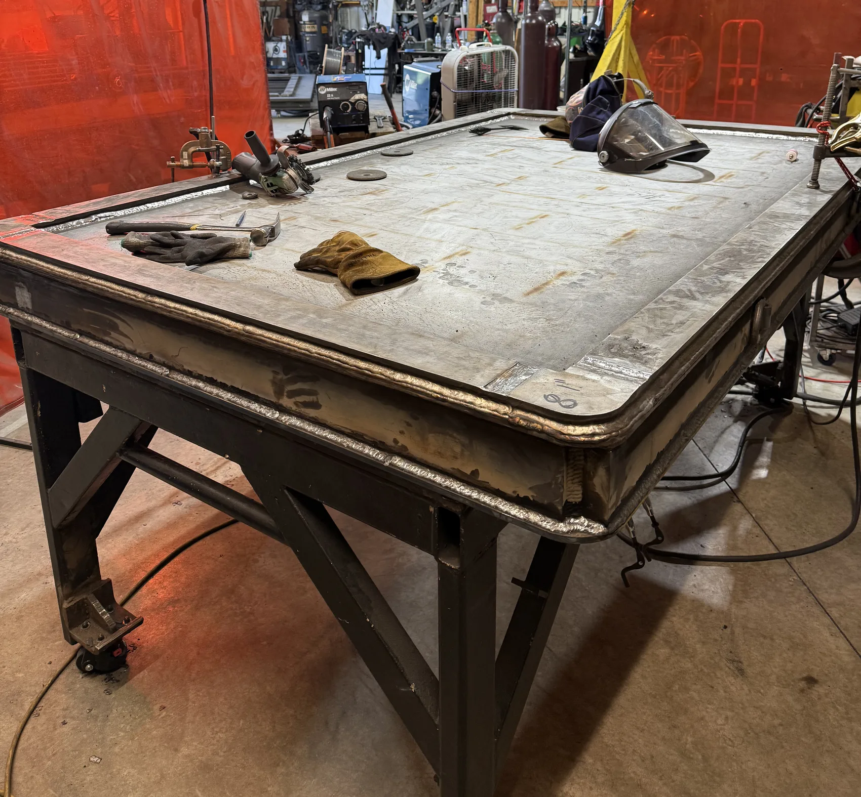 A skinned door panel on the table - the heater-channel grid sealed inside, ready for finish work.