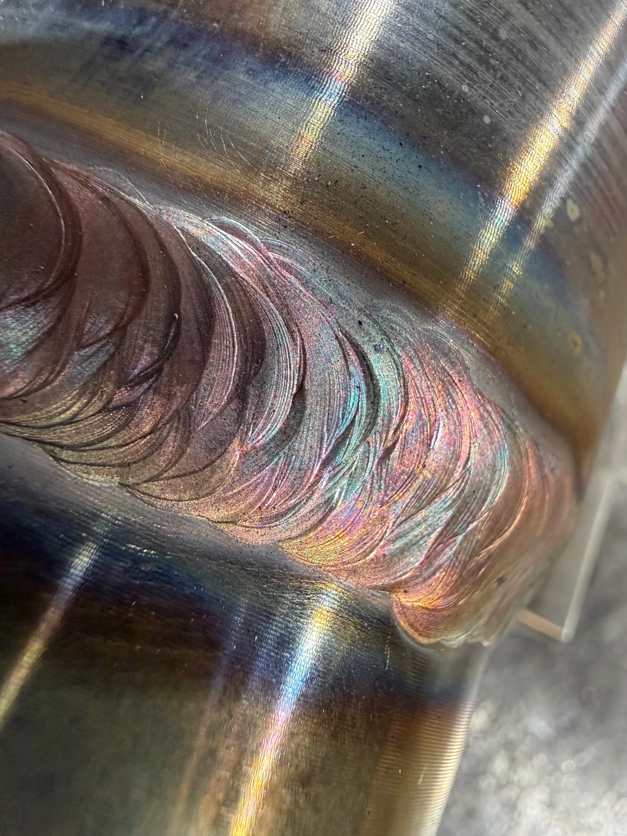 Stacked-dime TIG bead on stainless - the sanitary, food-grade weld quality this exhaust system is built on.