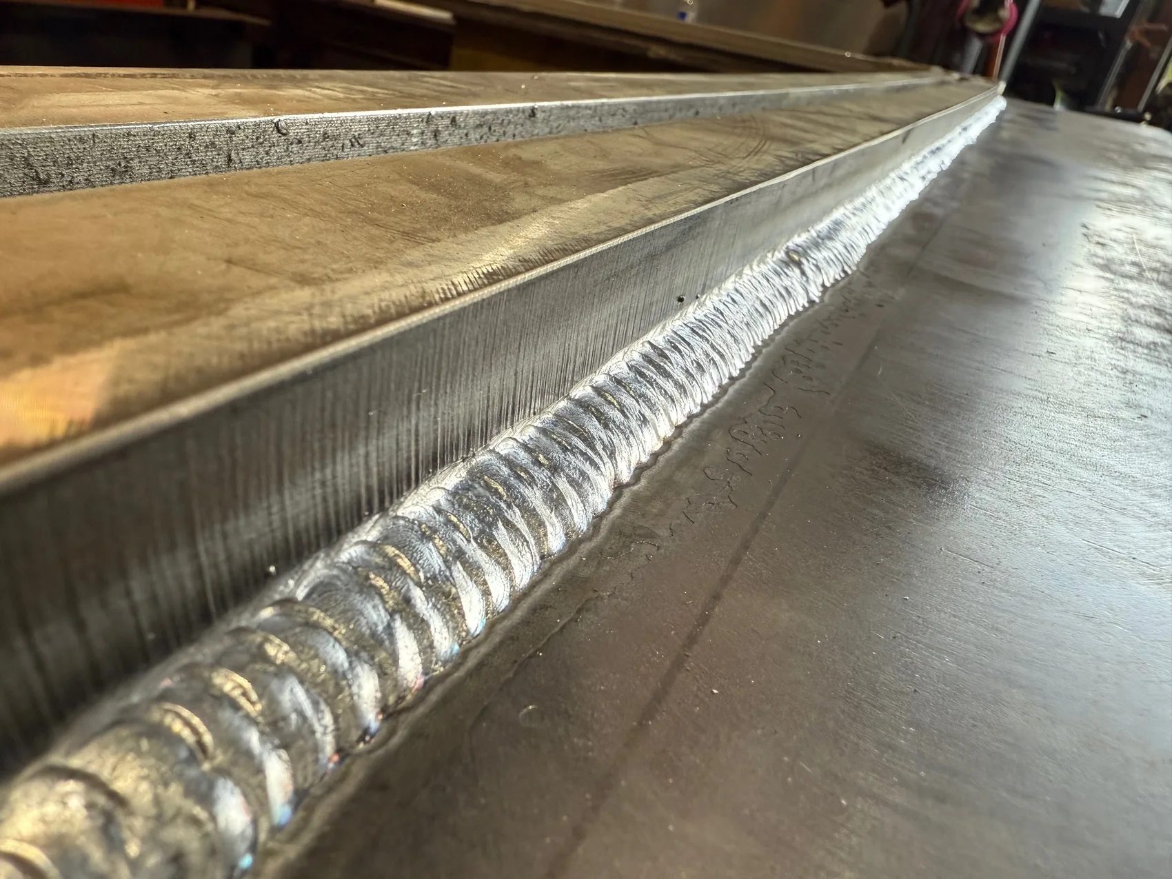 A stacked-dime weld bead along a steel seam