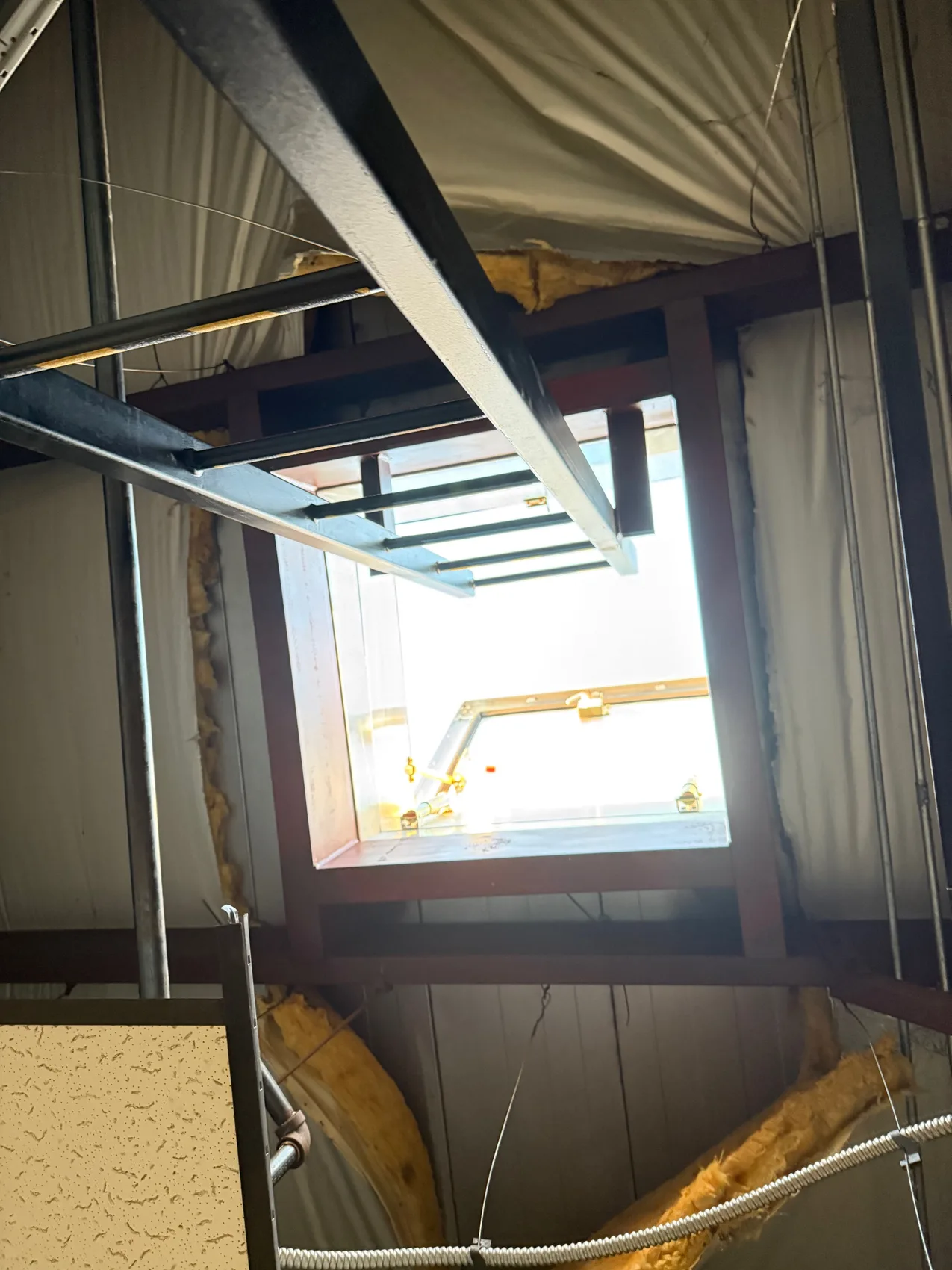 Roof-hatch opening framed in steel from below