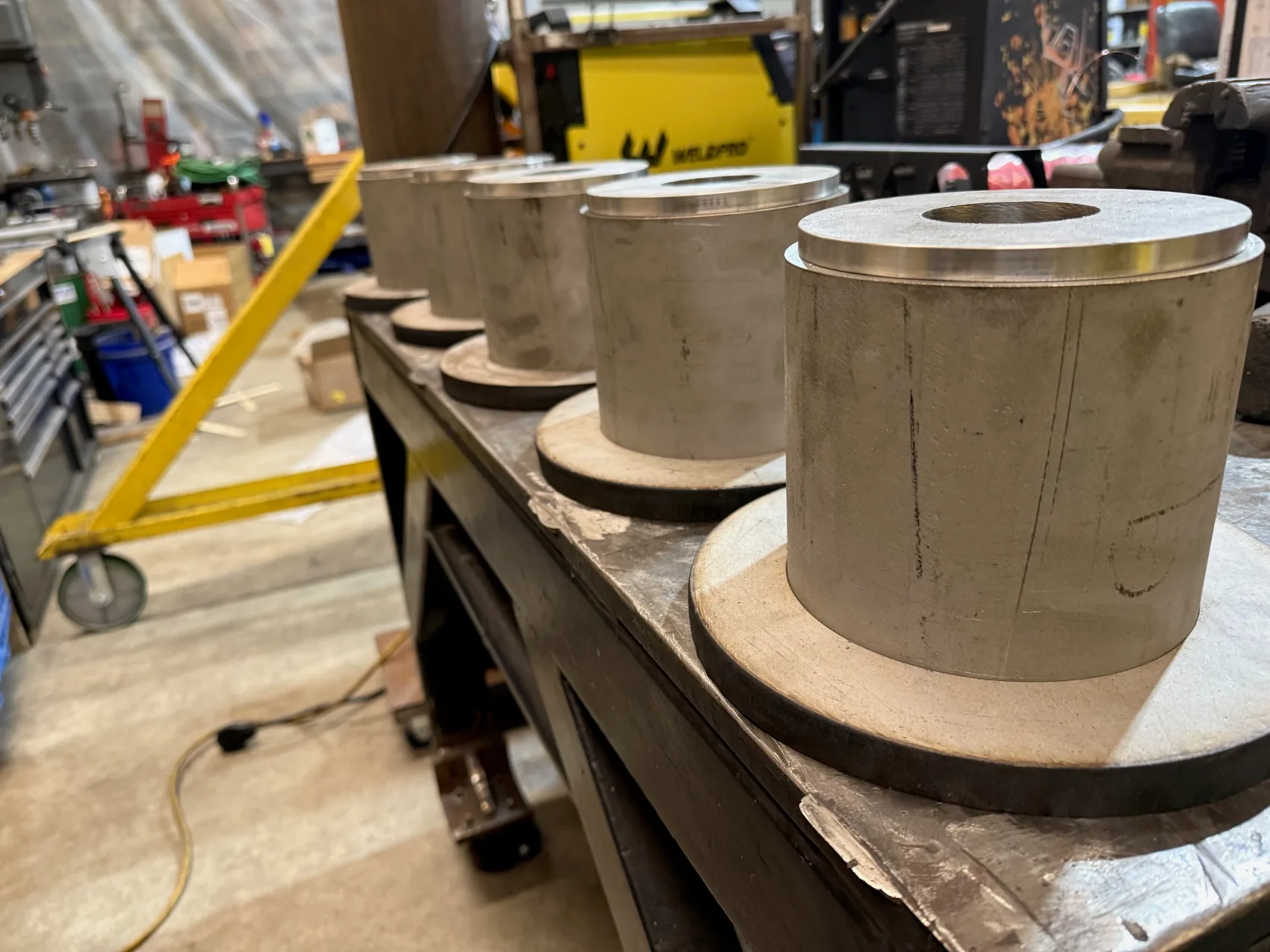 A row of machined stainless pulleys