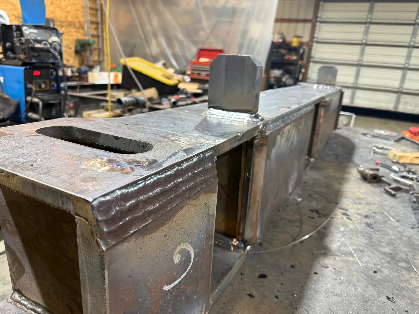 Box-housing weldment signed in soapstone