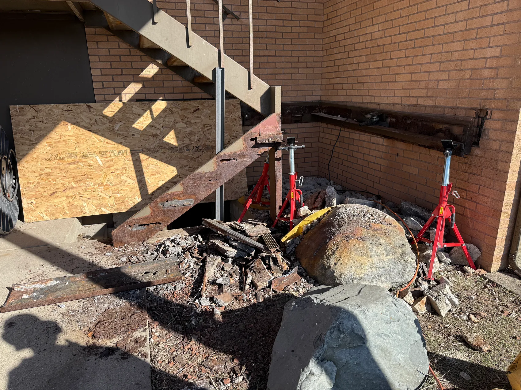 Demolishing the rusted egress stair