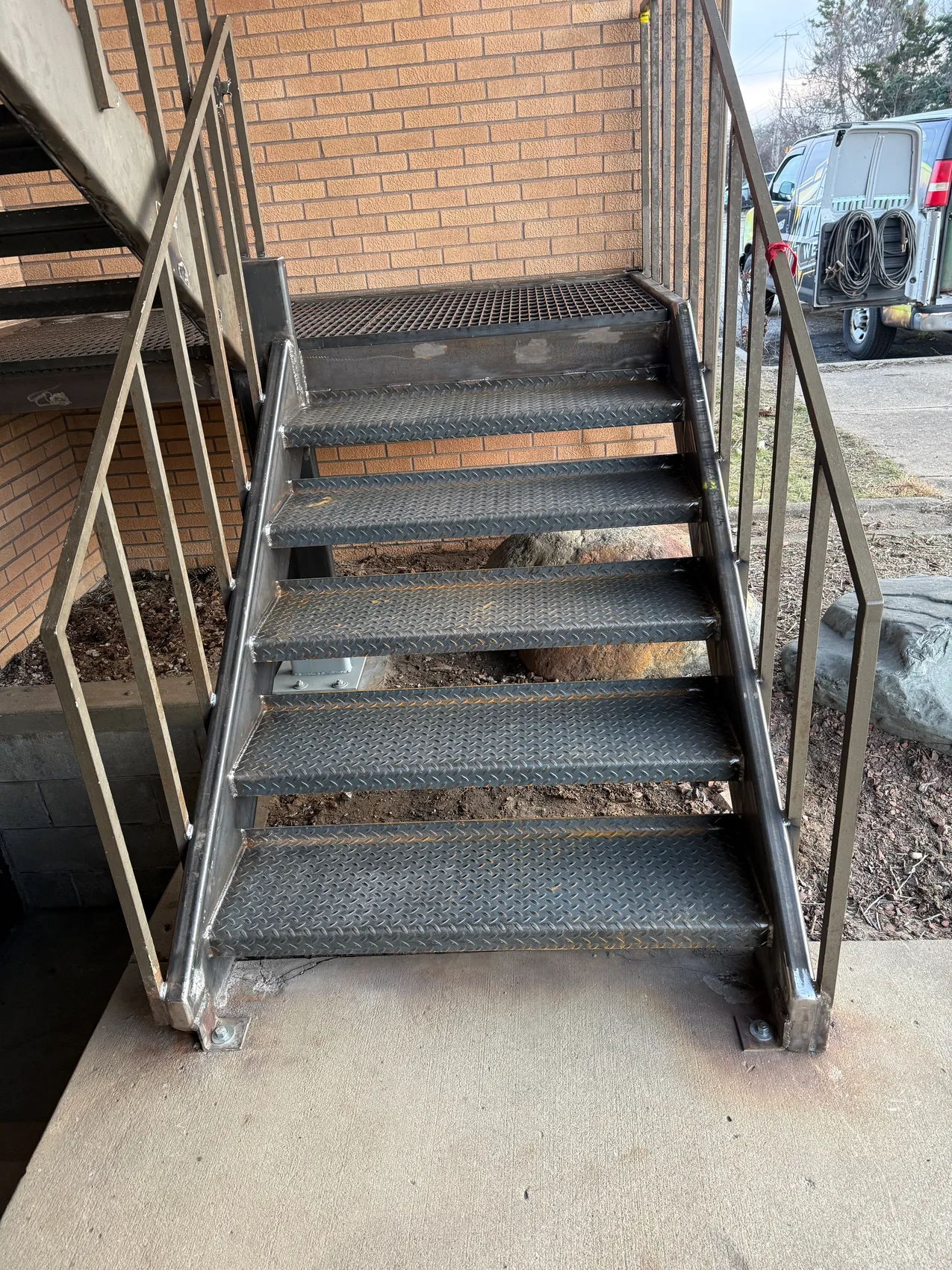 Finished egress stair with diamond-plate treads