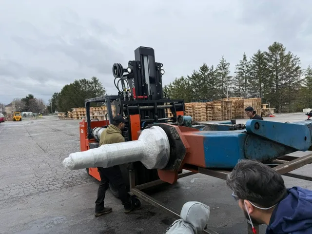 Crew loading a wrapped assembly for delivery
