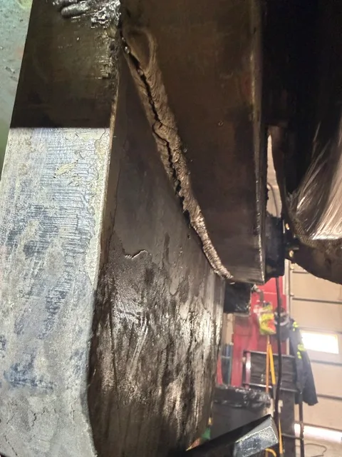 The failure that started it: a crack ripping through a member 2-3 inches thick on a cradle spinning at 120 RPM.