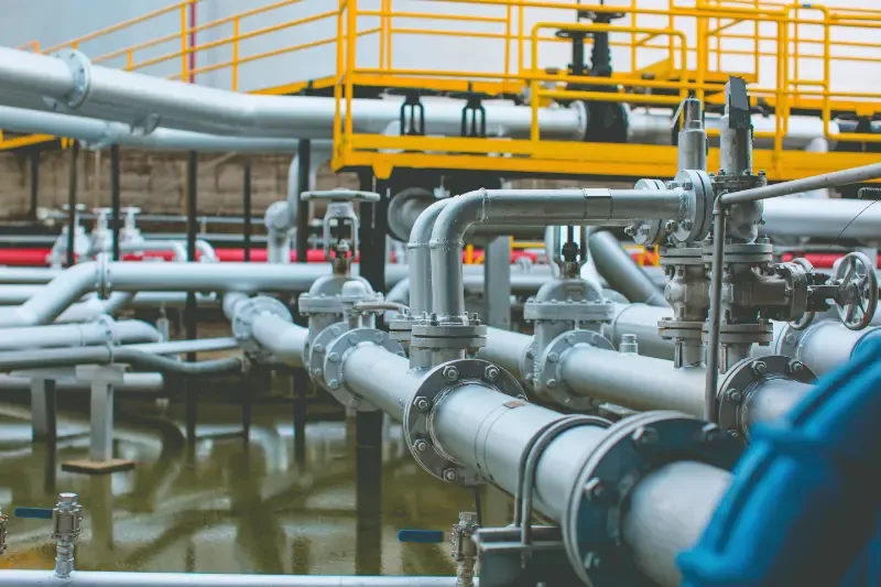 Industrial process piping rack with flanged valves and steel manifolds