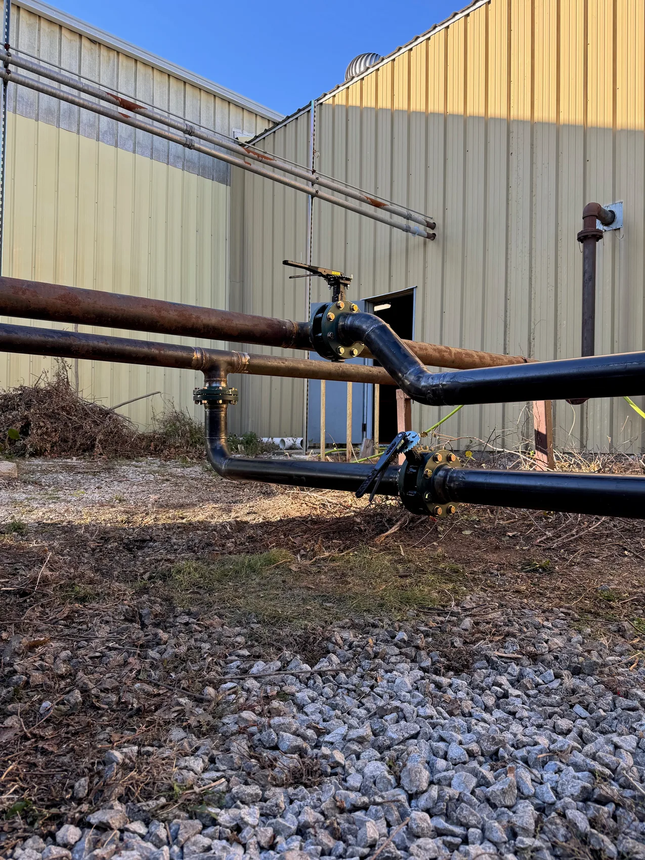 Heavy blue rotating machine cradle and shaft staged for structural weld repair by Sons of Thunder Welding