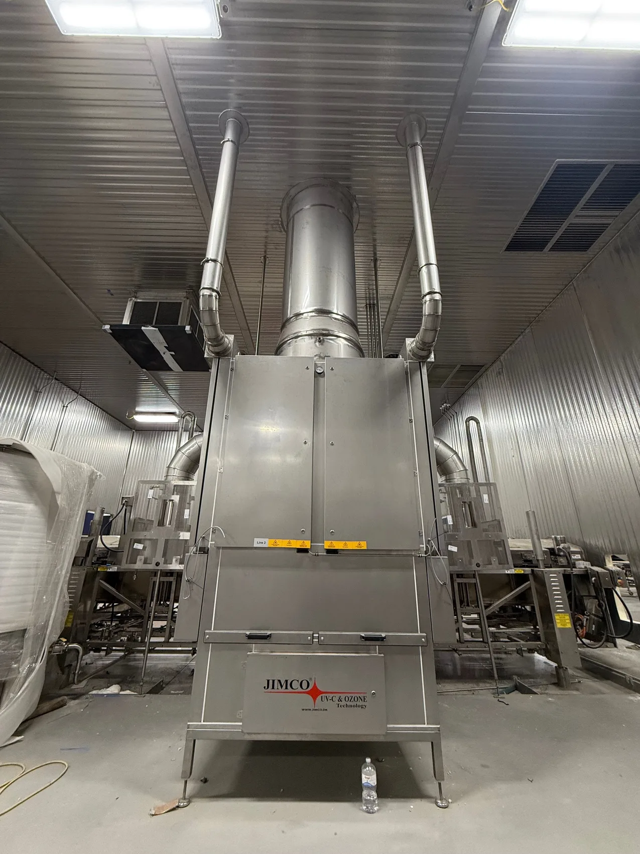 Food-processing room with stainless fryer lines and looping overhead stainless exhaust ductwork by Sons of Thunder Welding